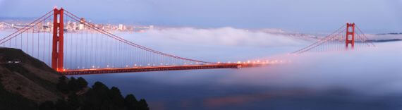 Aerial view of fog coming through the Golden Gate Bridge