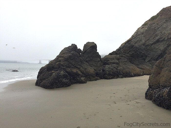 Rocks reaching out into the bay at China Beach